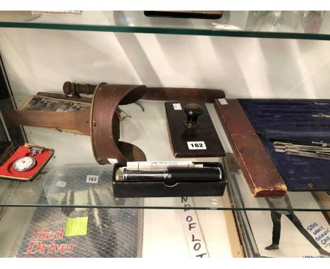 An Otis King calculator, geometry instruments, a slide rule, a truncheon, a stereoscopic viewer and a few slides