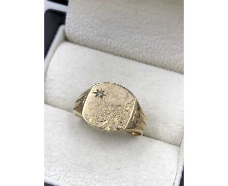 A 9ct hallmarked gold diamond signet ring. Finger size R 1/2. Weight 4.87 grams.
