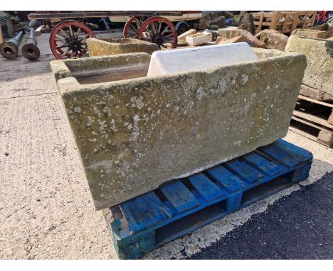 A large 19th-century carved stone cistern trough.