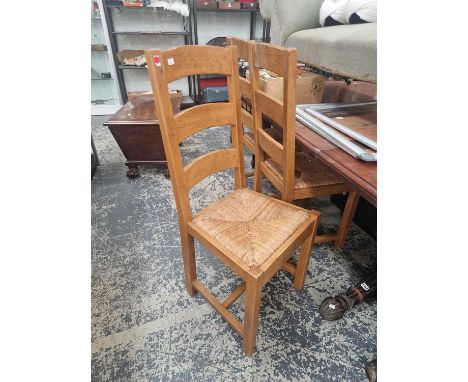 A set of eight rush seat ladder back chairs. 