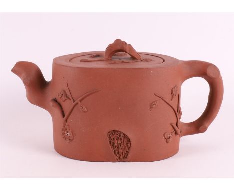 A Yixing tree trunk-shaped teapot, China 19th/20th century. Relief of prunus, marked with character mark on the inside of the