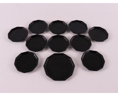 Netherlands, Leerdam. A 10-sided bottle tray with ten ditto coasters, made of satin black glass, design: K.P.C.de Bazel, 1920