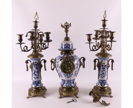A three-piece Jugendstil pendulum clock set, around 1900. Pendulum clock with brass floral crown and frame, the baluster-shap