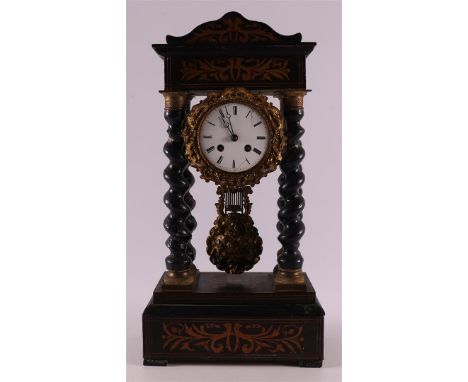 An ebonised glued column mantel clock, France, Napoleon Trois, ca. 1870. Capital and base with applications in floral motifs,