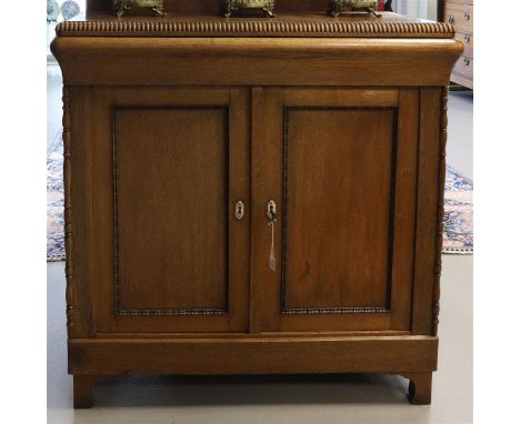 A two-door penant cabinet, late 19th century. Oak, rectangular top with beading and below that one drawer, two panel doors, f