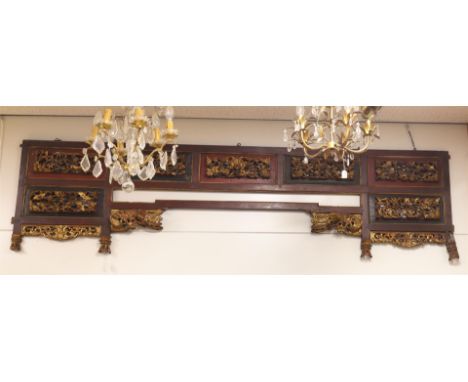 A carved wooden top panel, China, republic, 20th century. Ajour floral decor with phoenixes and dragons, h 63 x w 238 cm.