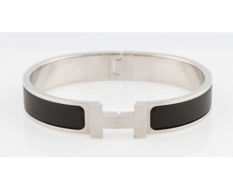 A Hermes Clic Clac H bangle, with black panels, with pouch and box.