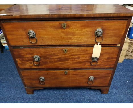 A Georgian mahogany chest of three long drawers on bracket feet.