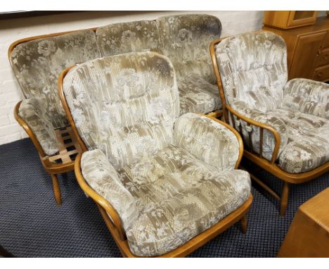 An Ercol four piece stick back lounge suite, (settee, two chairs and stool).