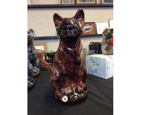 An 'Ewenny Pottery' ceramic cat in mottled brown and orange design, engraved on base and label titled 'St Fagans'. Height 34c