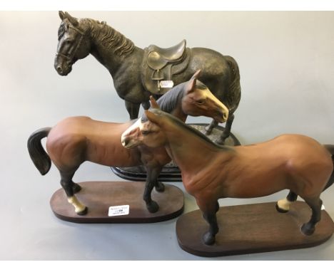 A large horse with saddle by Leonard and two large ceramic horses.
