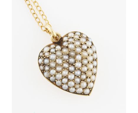 An seed pearl set heart pendant, engraved reverse 'To The Sweet of Heart', stamped 15ct, on an unmarked yellow metal curb lin