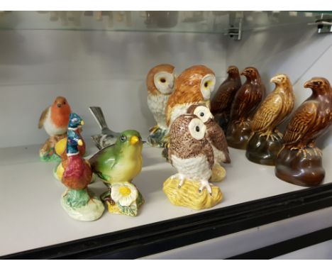 A collection of Beswick Bird ornaments, including four Scotch Whisky containers, (13 items in all).