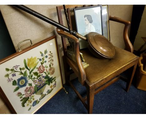 An oak framed elbow chair, a collection of pictures, a patterned rug, warming pan and brass door stop, firescreen, small rose