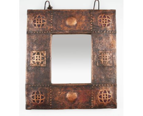 An Arts and Crafts hand beaten copper wall mirror with four enamel insets and raised studs, 51cms x 46cms.