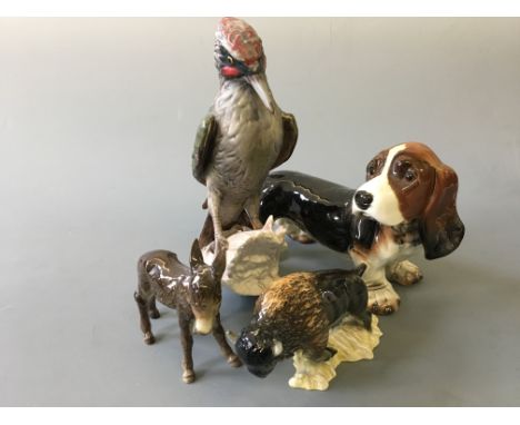 Four Goebel figures, woodpecker, dog, donkey, Bison.