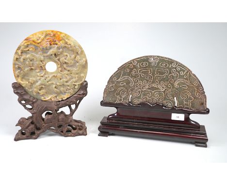 2 bi-discsJadeite, nephrite; 1x disc, front with three-dimensional tigers, back with graphic patterns, on carved wooden stand