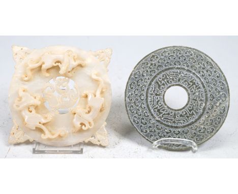 2 bi-discsJadeite, nephrite; 1 x white jadeite, fully plasticised dragon depiction on the front, grain pattern on the back. G