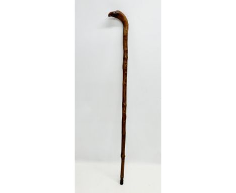 An Early 20th Century walking stick with natural formed eagle head. 85cm