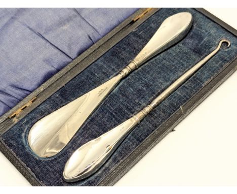 An Early 20th Century silver handled shoe horn with matching silver handled button hook by Crisford &amp; Norris Ltd. In case