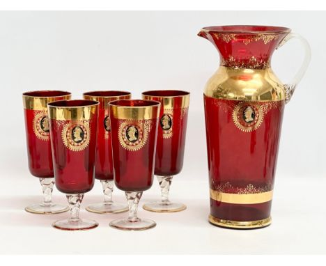 A Venetian Murano 6 piece gilt and Ruby glass drinks set. 5 glasses 18.5cm. Pitcher jug 29.5cm. Mid 20th Century.