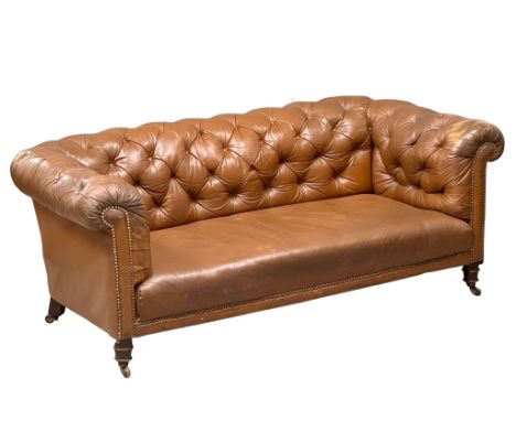 A 19th Century Victorian deep button leather Chesterfield sofa, on turned mahogany legs. Circa 1880. 184x89x71cm
