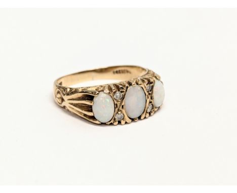 A 9ct gold ring with 3 multi fire opals. Size UK R