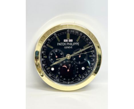 A Patek Philippe advertising wall clock. 40cm