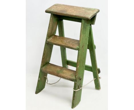An Early 20th Century folding step ladder with original paint. 71cm folded.