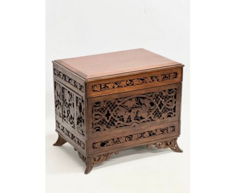 A Late 19th/Early 20th Century teak table top drinks cabinet with open fretwork carving 35x25x30cm