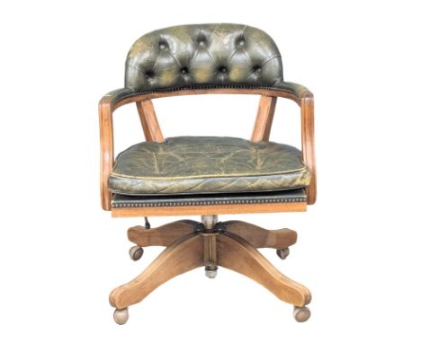 A vintage Victorian style deep button leather swivel desk chair.