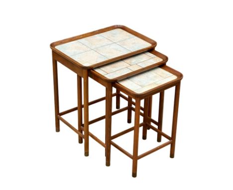 A tall Mid Century teak nest of table with tile tops.