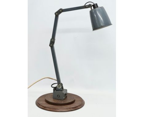 A large 1950’s industrial rotating anglepoise lamp, on wooden base. Memlite. 33x84cm