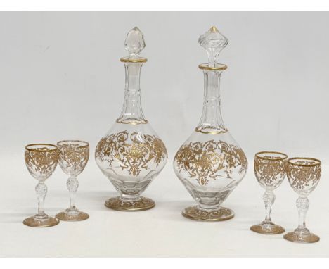 A fine quality Late 19th/Early 20th Century French gilt enamel drinks service. A pair of decanters 23cm. 4 glasses 9cm