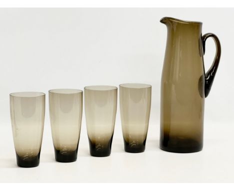 A Danish Mid Century smoked glass drinks set. Pitcher 29cm. 4 glasses 14.5cm