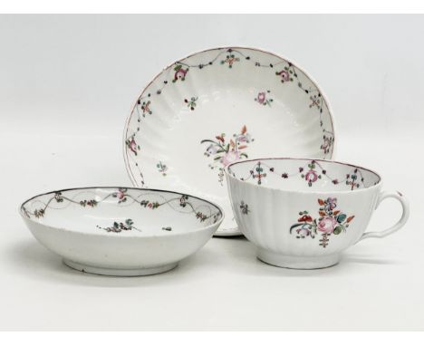 New Hall. A Late 18th Century trio tea cup and saucer set. Circa 1790. Tea cup 12x10.5x5.5cm. Saucer 15.5x3.5cm. Saucer 13x3.