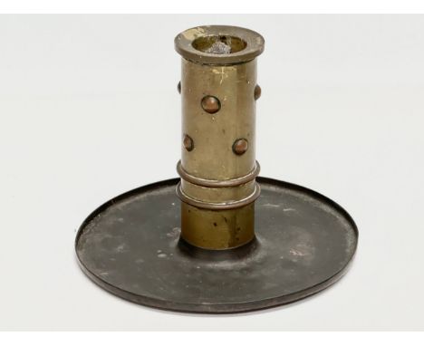 A Trench Art Arts &amp; Crafts style brass and copper candlestick. 14.5x11.5cm