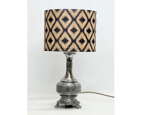 The Silverlight Company Limited. A large embossed plated French table lamp. 56cm with shade. Base 41cm