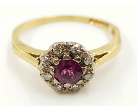 An 18ct gold, ruby and diamond cluster ladies ring. 2.9g total weight and size N. 
