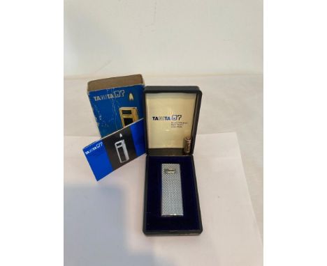 Vintage Tanita Electronic LIGHTER. Complete with original case, box and booklet.  Silver Tone with chased design.  Extremely 