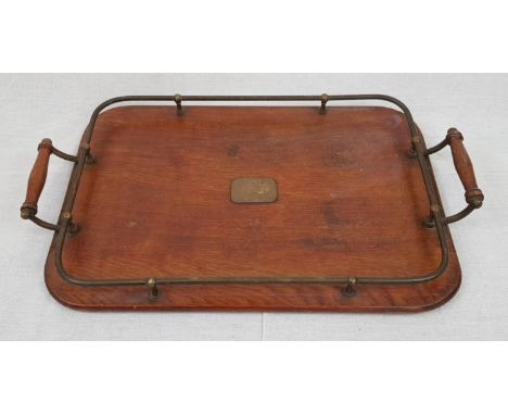 A Vintage, possibly Antique Wood Serving Tray. Comes with metal surround plate guard and wood handles.49 x 30cm 