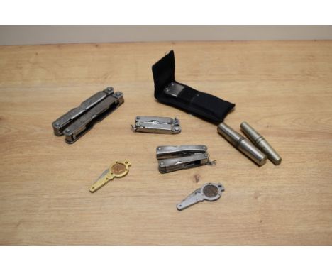 An assorted collection of multi-tools, vintage corkscrews, and two early 20th Century Farthing pocket knives, dates 1939 and 
