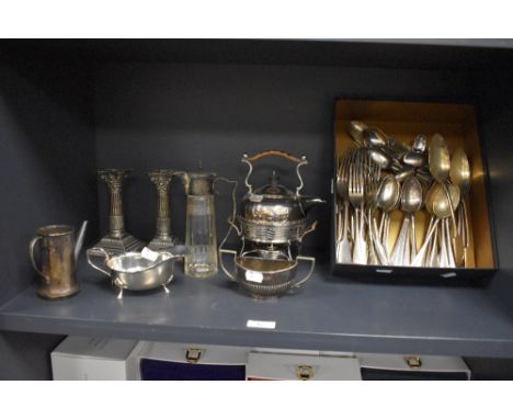 A collection of vintage flatware, a pair of silver plated candlesticks of column form, a small teapot on trivet with wicker b
