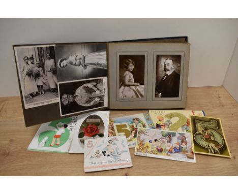 An album containing a selection of Postcards of Royal Family interest, also included are a few vintage birthday cards and bir