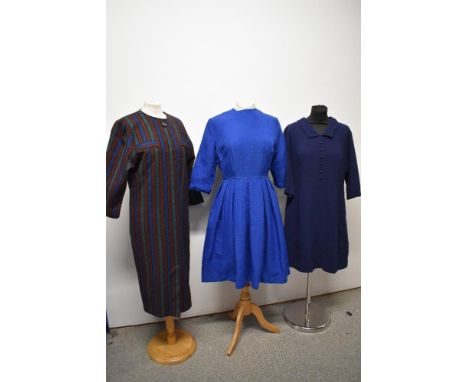 Three vintage dresses, including two 1960s shift dresses and a blue 1950s day dress with pleated skirt.