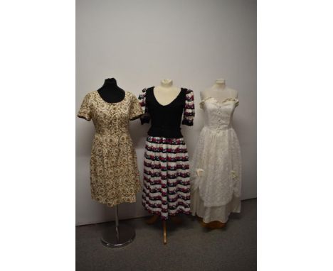 Three vintage dresses, including bright floral dress with contrasting black faux waistcoat.
