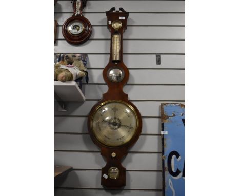 A large late 18c early 19c mahogany banjo barometer having integral convex mirror and boxwood inlay.