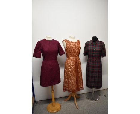 Three vintage 1950s to 1960s dresses, including plaid cotton in a larger size, with belt.