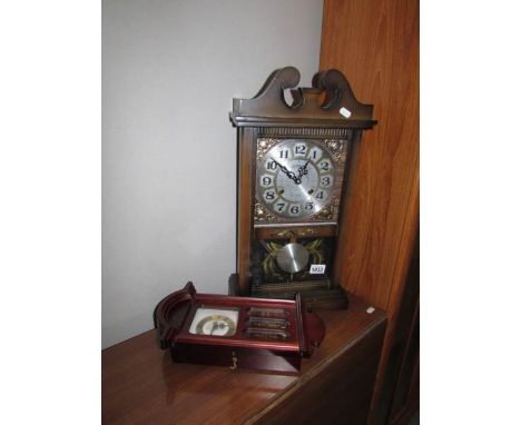 A mantel clock and a small wall clock