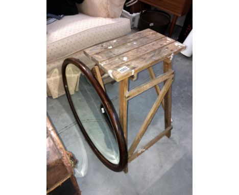 A oval bevel edged mirror and wooden step ladder
